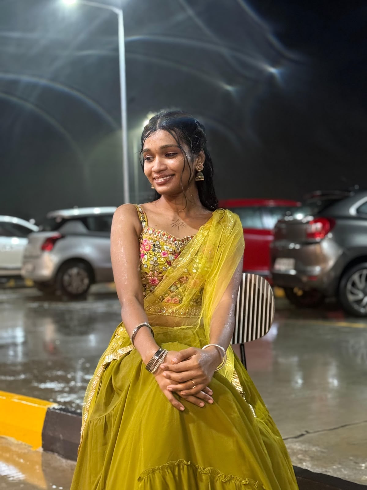 You smiling in the rain in your bright green traditional outfit.