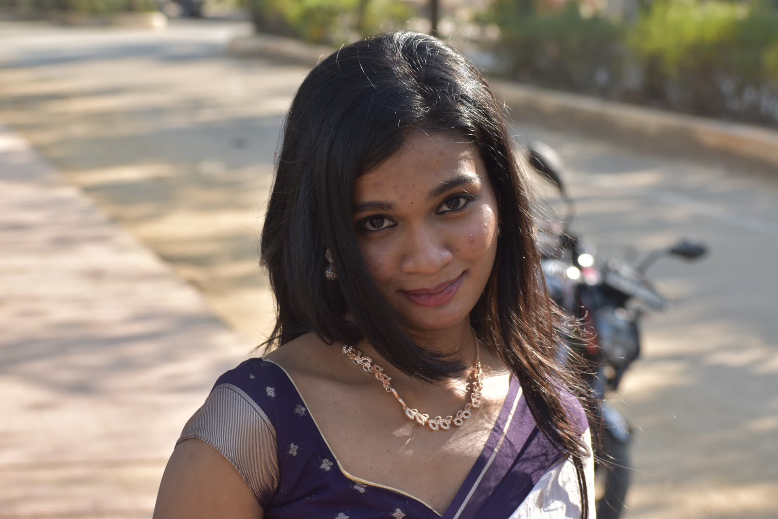 A sunlit close portrait of you in your cream and navy sari.
